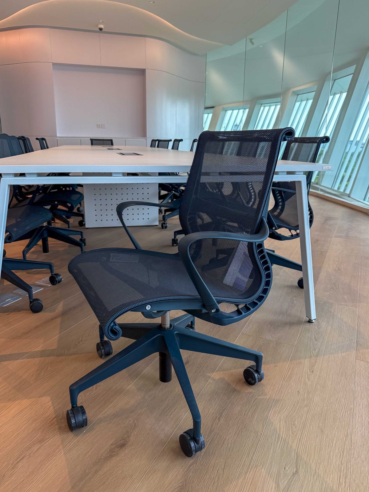 Setu chair in a meeting room with curved windows and wood floor